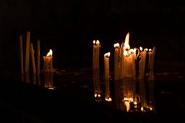 Candles flame reflection in water in dark