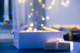 Magic background with gifts, dust and light for Christmas
